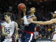 Saint Mary&#039;s forward Calvin Hermanson, right, fouls Gonzaga guard Eric McClellan, center, during the first half of an NCAA college basketball game for the West Coast Conference men&#039;s tournament championship Tuesday, March 8, 2016, in Las Vegas. Saint Mary&#039;s guard Joe Rahon is on the left.