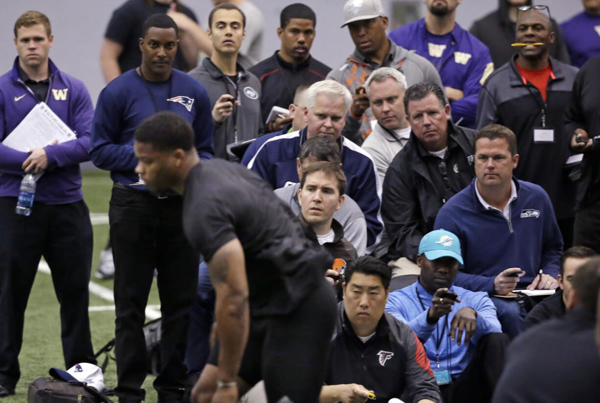 Scouts look on as Dwayne Washington runs through a drill at Washington&#039;s NFL football Pro Day Thursday, March 31, 2016, in Seattle.