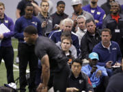 Scouts look on as Dwayne Washington runs through a drill at Washington&#039;s NFL football Pro Day Thursday, March 31, 2016, in Seattle.