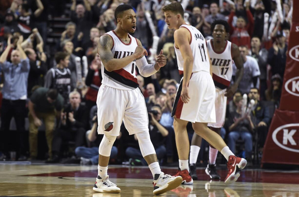 Portland Trail Blazers guard Damian Lillard (0) reacts after hitting a shot during overtime of an NBA basketball game against the Washington Wizards in Portland, Ore., Tuesday, March 8, 2016. Lillard scored 41 points as the Blazers won 116-109.