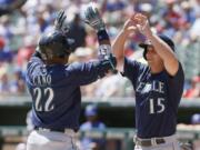Seattle Mariners&#039; Robinson Cano (22) is congratulated by Kyle Seager (15) after hitting a two run home run during the first inning of a baseball game against the Texas Rangers Wednesday, April 6, 2016, in Arlington, Texas.