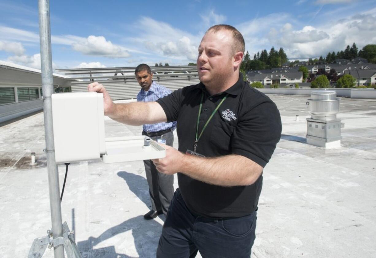 Facilities technician Adam Norman collects pollen samples last year as Dr. Raj Srinivasan looks on at the Vancouver Clinic in Salmon Creek. This year&#039;s allergy season is off to an early start.