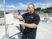 Facilities technician Adam Norman collects pollen samples last year as Dr. Raj Srinivasan looks on at the Vancouver Clinic in Salmon Creek. This year&#039;s allergy season is off to an early start.