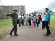 Acting Chief Ranger Bob Cromwell, left, and Kaiser pediatrician Dr. Mike Wilmington, right, lead a walk Saturday along the Spruce Mill Trail at Fort Vancouver.