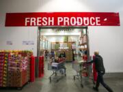 Shoppers check out the produce department recently at Costco in Issaquah. The warehouse giant is increasing its focus on organics, a fast-growing food category.