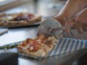 Owner/chef Dice-K Matsumoto cuts into Calzone Napoletana on Tuesday afternoon at Pizzeria La Sorrentina.