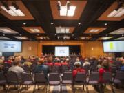 The audience and speakers are seen at a hearing to discuss the extension of the oil terminal lease, held by the Port of Vancouver at Clark College in Vancouver Tuesday April 12, 2016.