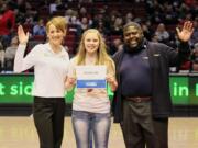 Mountain View: Christina Lundy, center, pictured with two CarMax employees, was honored at a recent Blazers game after being named a CarMax Teen Captain.