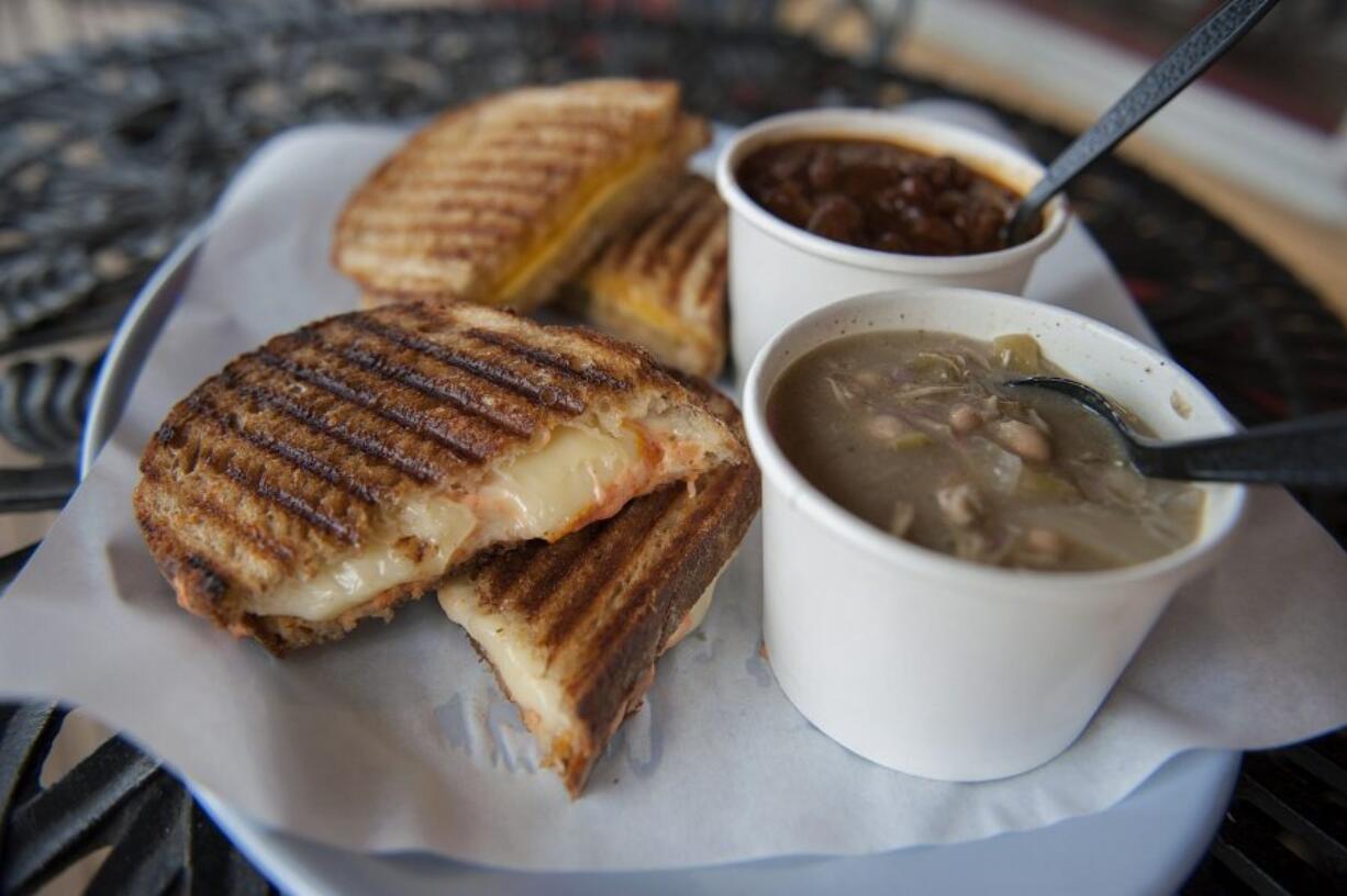 A toasted four-cheese sandwich with spicy sauce, left, and white bean chicken chili are served April 13 at Buckets in Ridgefield. A Grandpa Bud sandwich, background left, is a magical mix of peanut butter, cheddar and dill pickle, grilled, and is served with the vanilla porter stout chili.