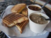 A toasted four-cheese sandwich with spicy sauce, left, and white bean chicken chili are served April 13 at Buckets in Ridgefield. A Grandpa Bud sandwich, background left, is a magical mix of peanut butter, cheddar and dill pickle, grilled, and is served with the vanilla porter stout chili.