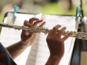 Musician Adam Fahnestock with the Vancouver Pops Orchestra, plays his flute at an afternoon summer concert at Esther Short Park in Vancouver on July 6, 2011.