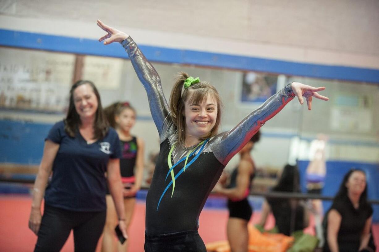 Gymnast Gigi Gernhart finishes her bar routine with a flourish Monday afternoon, April 11, 2016 at Naydenov Gymnastics.