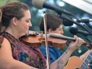 Aarun Carter plays fiddle on stage with Jonathan Trawick at the Clark County Folk Festival.