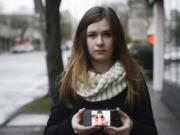 Tanya Mosh holds up a photo on her phone of her mother, Raisa Mosh, who was struck and killed, along with a friend, while in a crosswalk Jan. 19, 2014, on Northeast Vancouver Mall Drive.