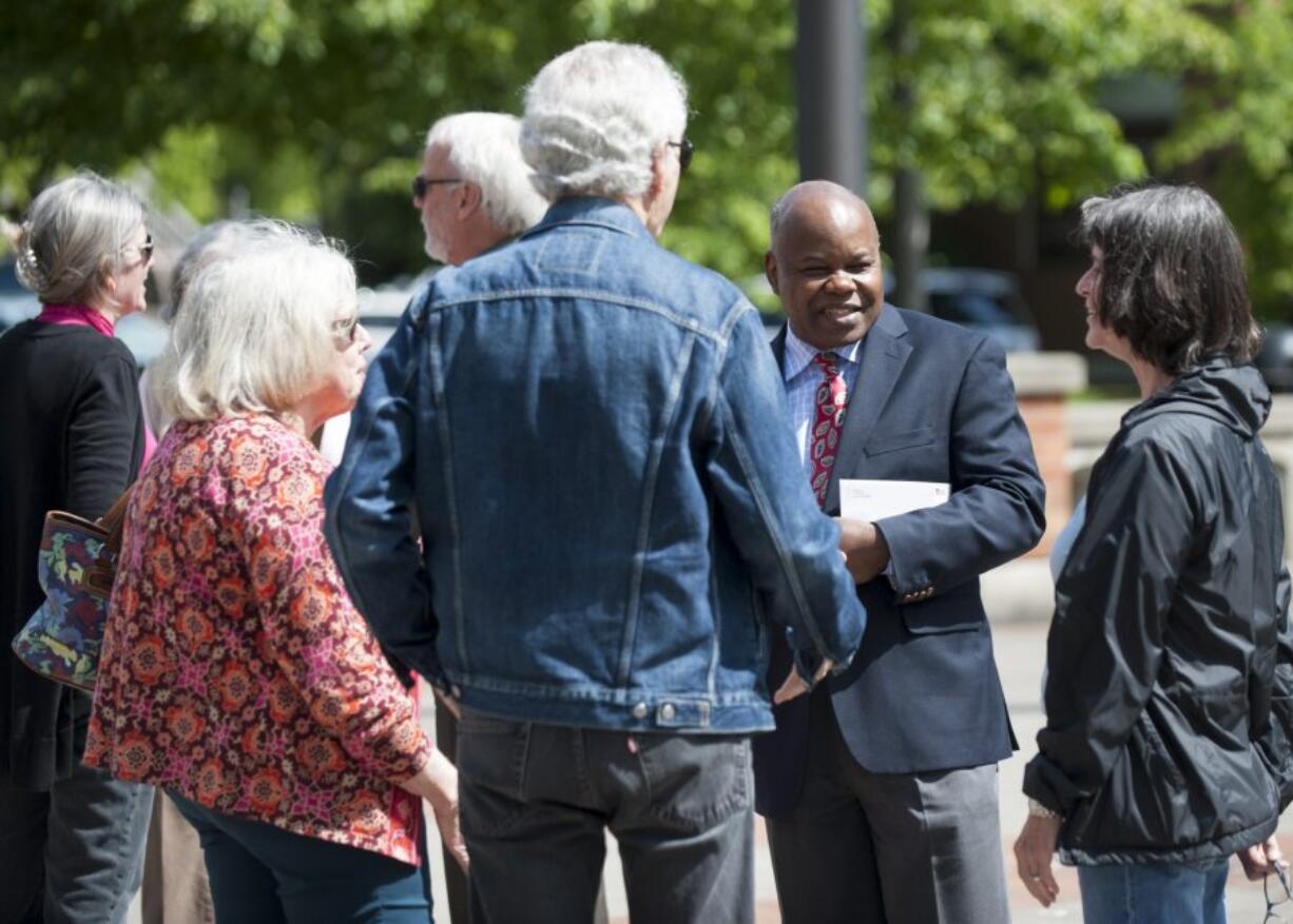 Clark County Community Planning Director Oliver Orjiako, second from the right, is seen surrounded by friends and supporters Tuesday outside the Public Service Center in downtown Vancouver. Clark County Councilor David Madore has accused Orjiako of lying about the county&#039;s growth plan.