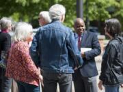 Clark County Community Planning Director Oliver Orjiako, second from the right, is seen surrounded by friends and supporters Tuesday outside the Public Service Center in downtown Vancouver. Clark County Councilor David Madore has accused Orjiako of lying about the county&#039;s growth plan.