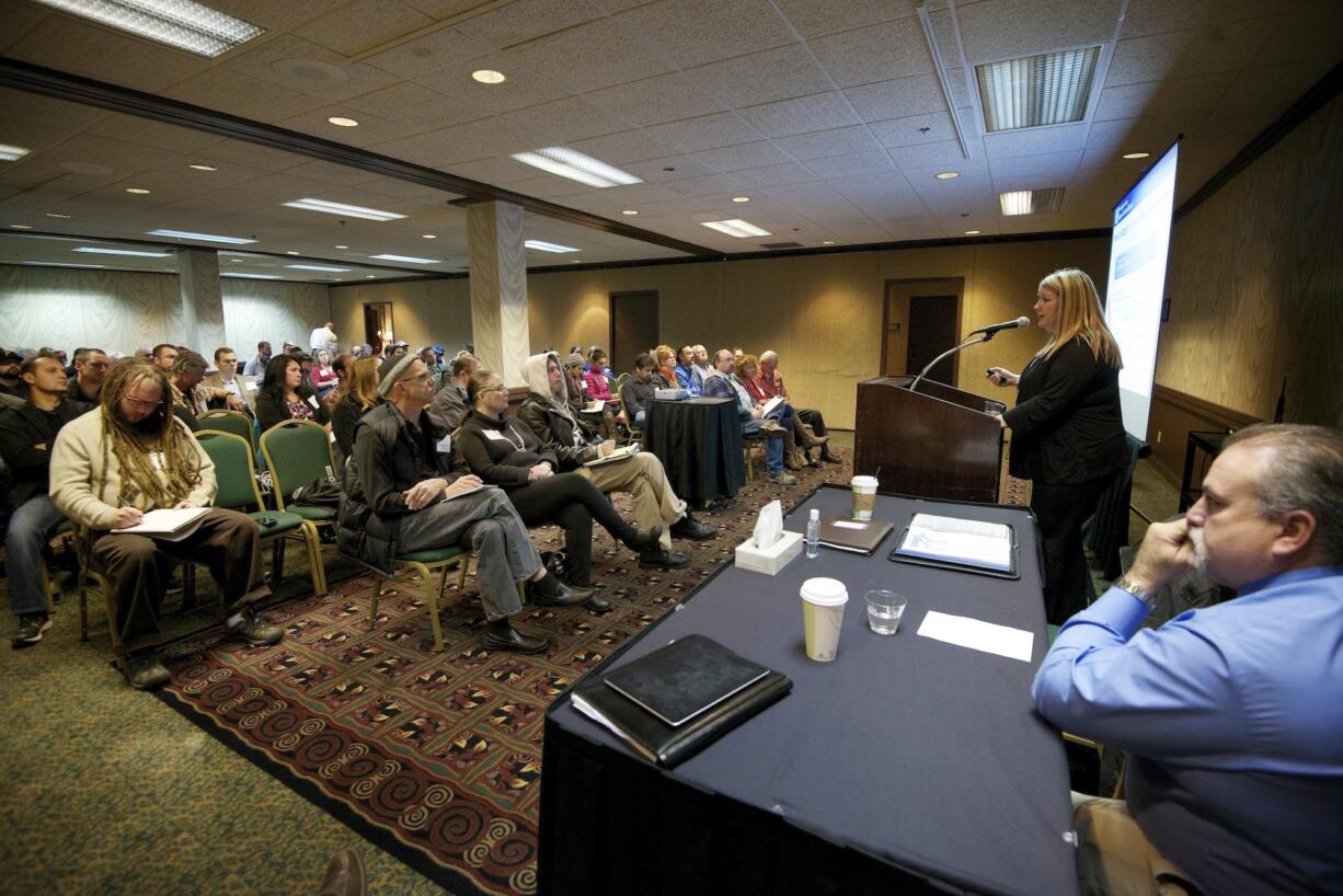 Nicola Reid, a marijuana licensing investigator with the Washington State Liquor Control Board, presents steps to become a licensed marijuana producer or retailer during an applicant workshop Nov. 1, 2013, in Vancouver. Of the eight businesses in the state that have had their licenses revoked as of late February, six were for state rules violations stemming from not revealing or misrepresenting who precisely owns a business, failing to provide required information or misrepresenting the facts in license information.