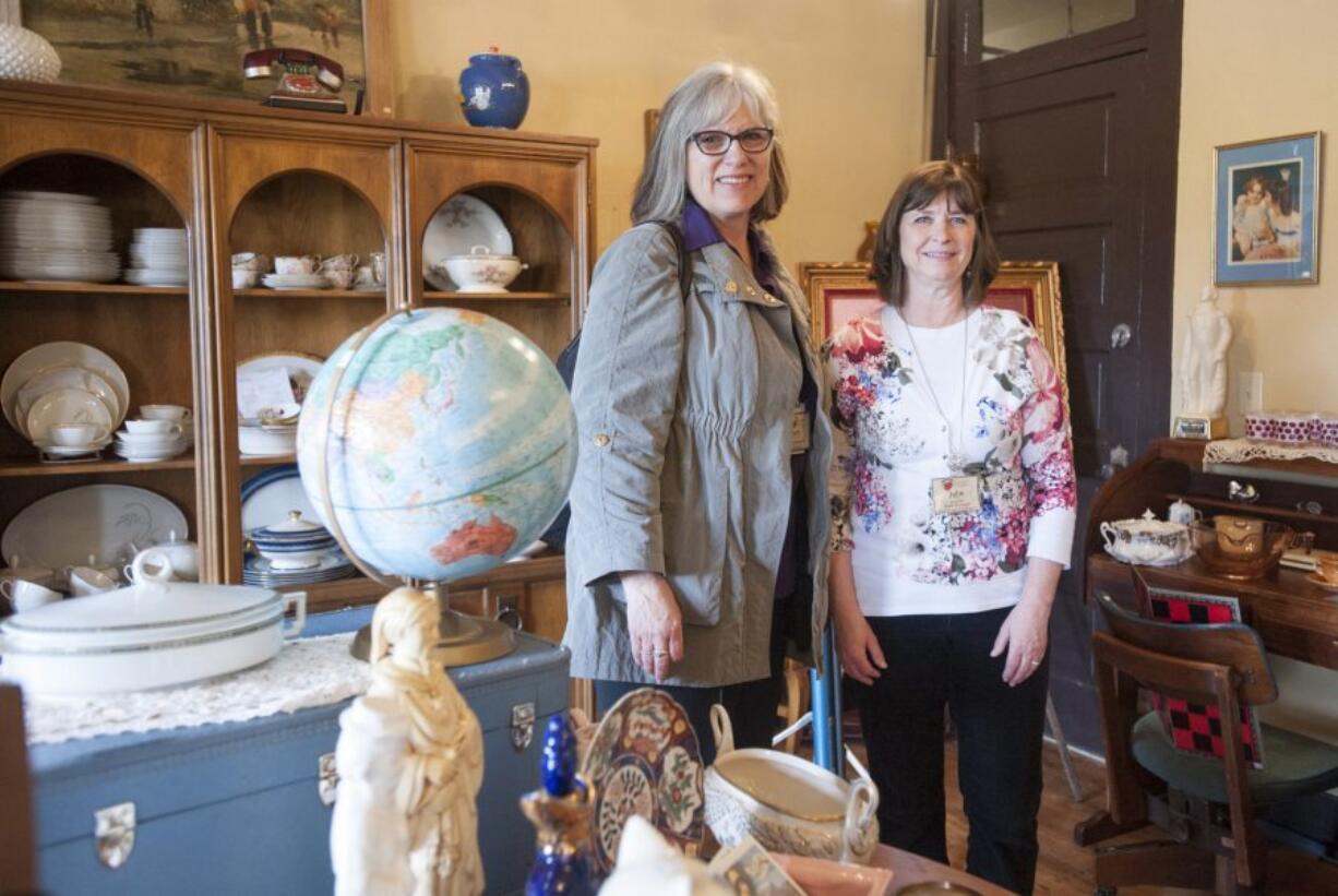 Second Hand Solutions store manager Julie Murray, right, with Judy McMorine, Open House Ministries development director, talk about the new vintage and antique shop opened at the nonprofit&#039;s retail building.