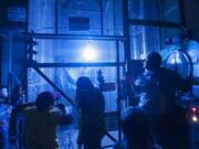 Electrical engineer Mick Johnson, right, demonstrates a corona flash Thursday at the Bonneville Power Administration&#039;s Ross Complex during Take Your Child to Work Day.