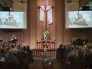 The Rev. Fitz Neal speaks at a memorial service for John McKibbin on Saturday at Columbia Presbyterian Church in Vancouver. Several hundred people attended the service for McKibbin, who died at 69 late last month when, while flying with passenger Irene Mustain, his World War II-era plane plunged into the Columbia River near Astoria, Ore.