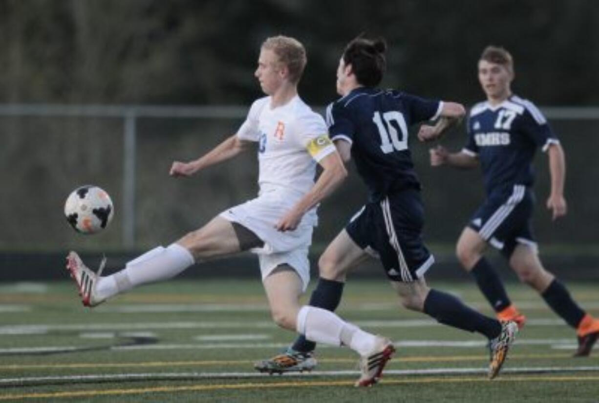 Ridgefield&#039;s soccer player Max Hauser, (left) battles with Mark Morris&#039; Elijah West (10).