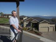 Bill Campbell takes in the view from his deck. He said he thinks the government should bury the proposed high-voltage power line to preserve views and property values, and to protect the environment.