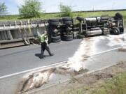 WSP Trooper Rob Gardiner surveys the scene where a tractor-trailer overturned on the northbound I-5 exit to Highway 14 in Vancouver on Monday.