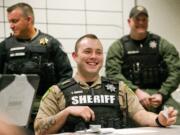 New Clark County Sheriff’s Deputy Ethan Ogdee, center, listens during a briefing before his graveyard shift. It took Ogdee more than a year to get hired, which isn’t atypical. While local agencies like the sheriff’s office are looking to ramp up their numbers, one of the things working against them is the lengthy hiring process.