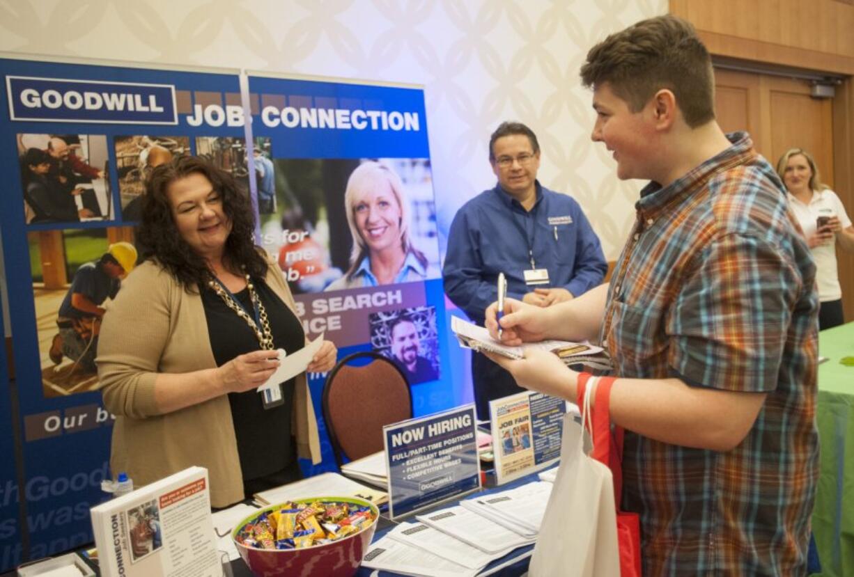 Cynthia Johnson, from left, of Goodwill Job Connection speaks with Evergreen High school senior Cory Wiese at the Digital Technology Expo on Thursday at the Hilton Vancouver Washington.