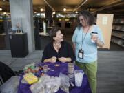 Artist Mandi Vee, center, shares a laugh with Ruth Shafer of the Vancouver Community Library while working on a beading project Friday morning, March 25, 2016.