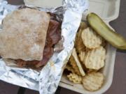 The Georgia Peach sandwich is served with chips and a pickle at the Pimento Cheese Kitchen food cart in Vancouver.