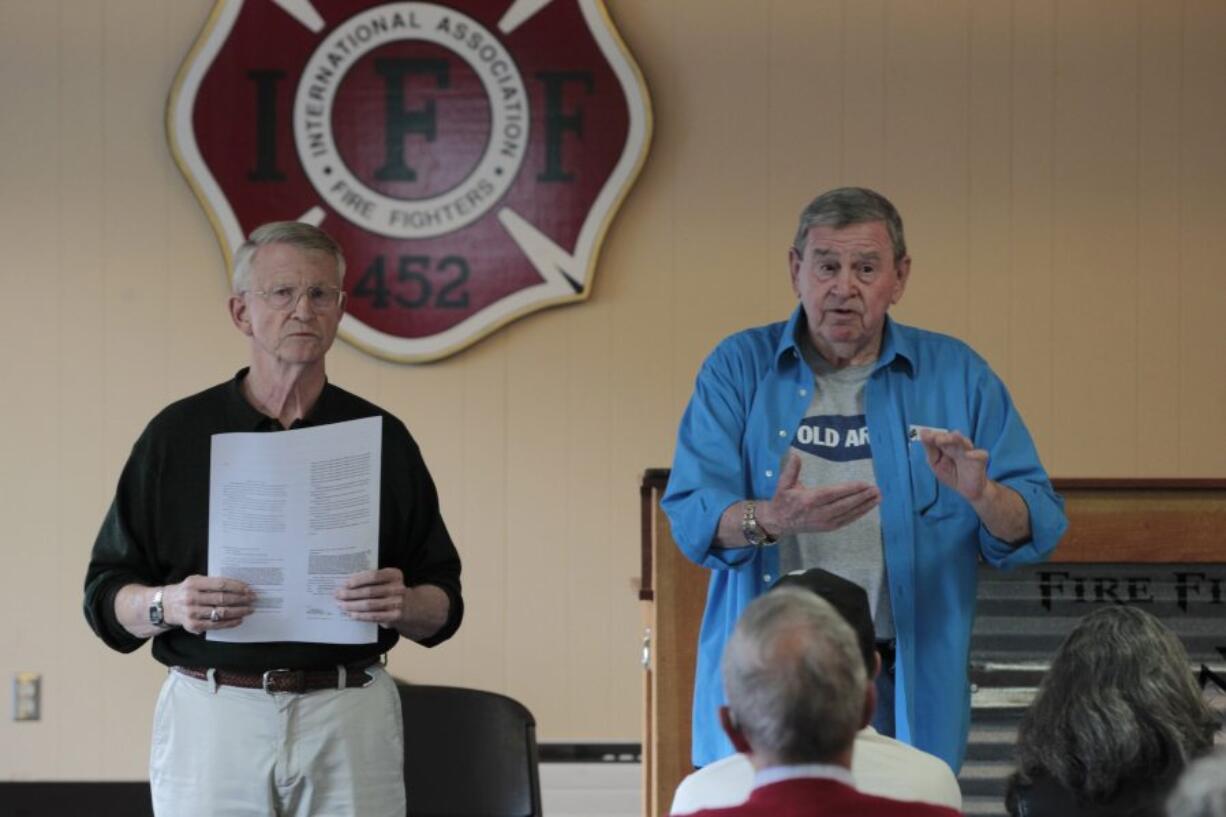 Former Vancouver Mayors Bruce Hagensen, left, and Royce Pollard, explain a petition drive in late April for a ballot measure that would ask voters if the pay increases recently granted to Vancouver's mayor and City Council should be repealed.