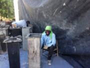 A worker with a water filter he has just removed from its mold at Clean Water for Haiti&#039;s new manufacturing center.