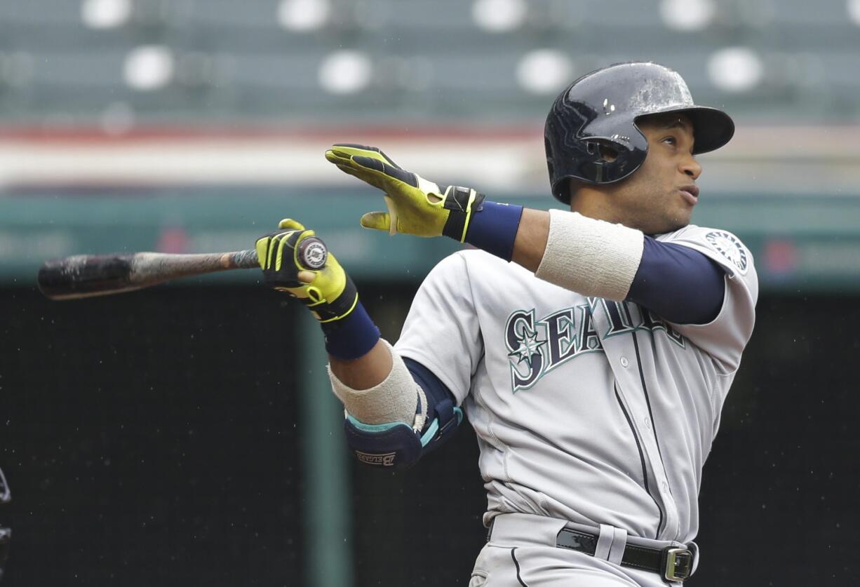 Seattle Mariners' Robinson Cano watches his ball after hitting a three-run home run off Cleveland Indians relief pitcher Cody Allen in the tenth inning of a baseball game, Thursday, April 21, 2016, in Cleveland. Franklin Gutierrez and Luis Sardinas scored on the play. The Mariners won 10-7.