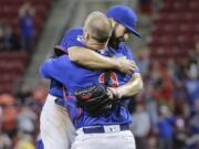 Chicago Cubs starting pitcher Jake Arrieta, left, celebrates with catcher David Ross after the final out of his no-hitter in a baseball game against the Cincinnati Reds, Thursday, April 21, 2016, in Cincinnati. The Cubs won 16-0.