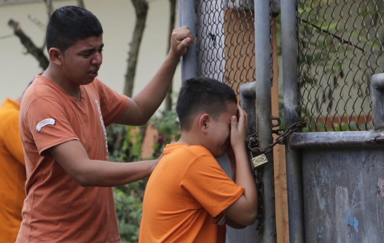 Boys cry Sunday as they find out that their sister was killed in an earthquake in Pedernales, Ecuador.