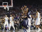 Villanova players celebrate after the NCAA Final Four tournament college basketball championship game against North Carolina, Monday, April 4, 2016, in Houston. Villanova won 77-74.(AP Photo/David J.