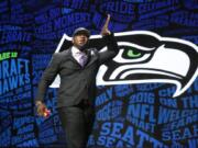 Jarran Reed celebrates after being selected by the Seattle Seahawks as the 49th pick in the second round of the 2016 NFL football draft, Friday, April 29, 2016, in Chicago.