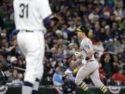 Seattle Mariners relief pitcher Steve Cishek waits as Oakland Athletics&#039; Chris Coghlan rounds the bases on his home run during the ninth inning of a baseball game Friday, April 8, 2016, in Seattle.