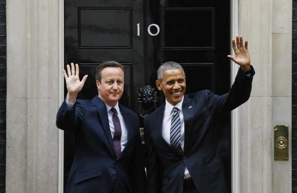 President Barack Obama and Britain's Prime Minister David Cameron wave from the steps of 10 Downing Street, London, before a meeting Friday.