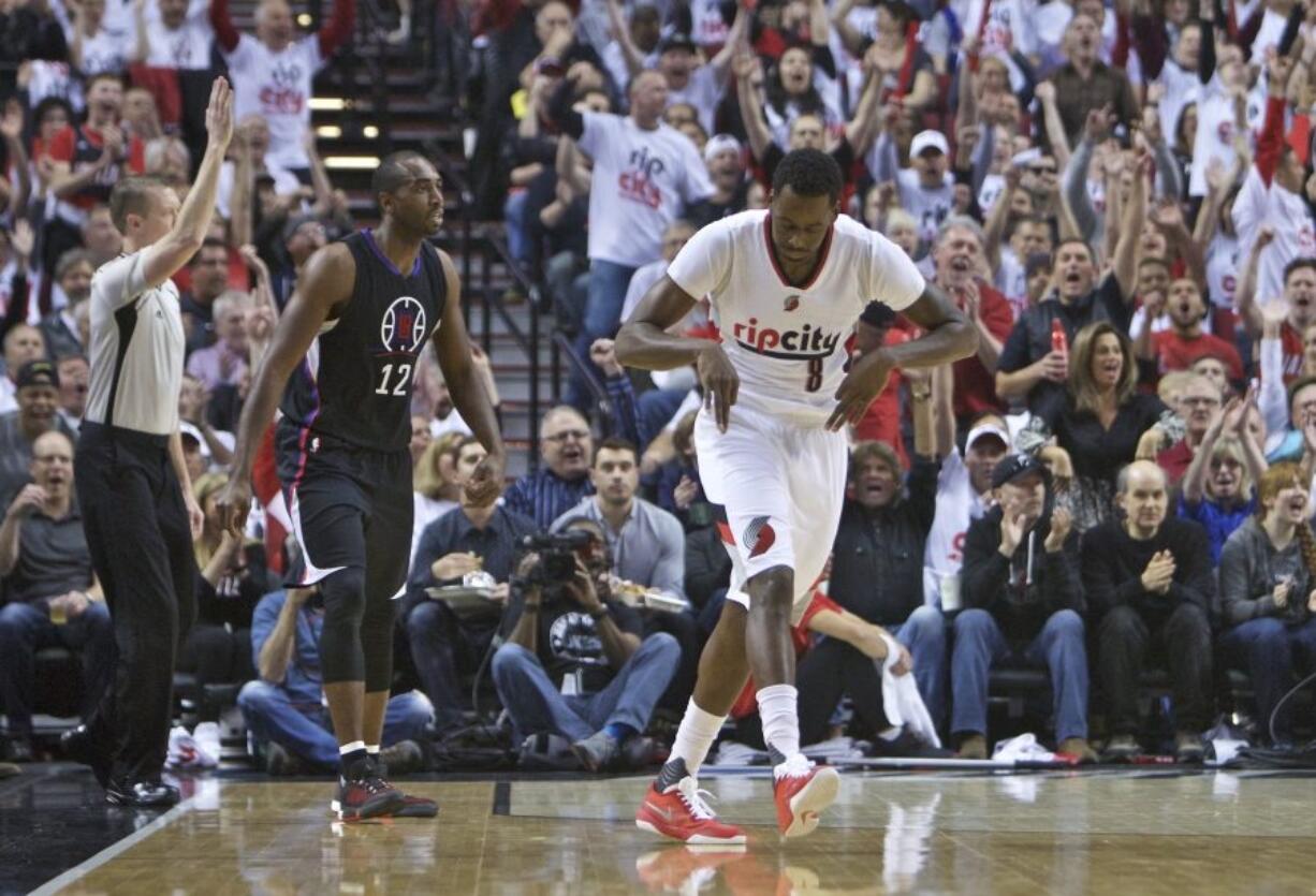 Portland&#039;s Al-Farouq Aminu (8) and Blazers fans celebrate after Aminu&#039;s three point basket over Clippers forward Luc Richard Mbah a Moute (12).