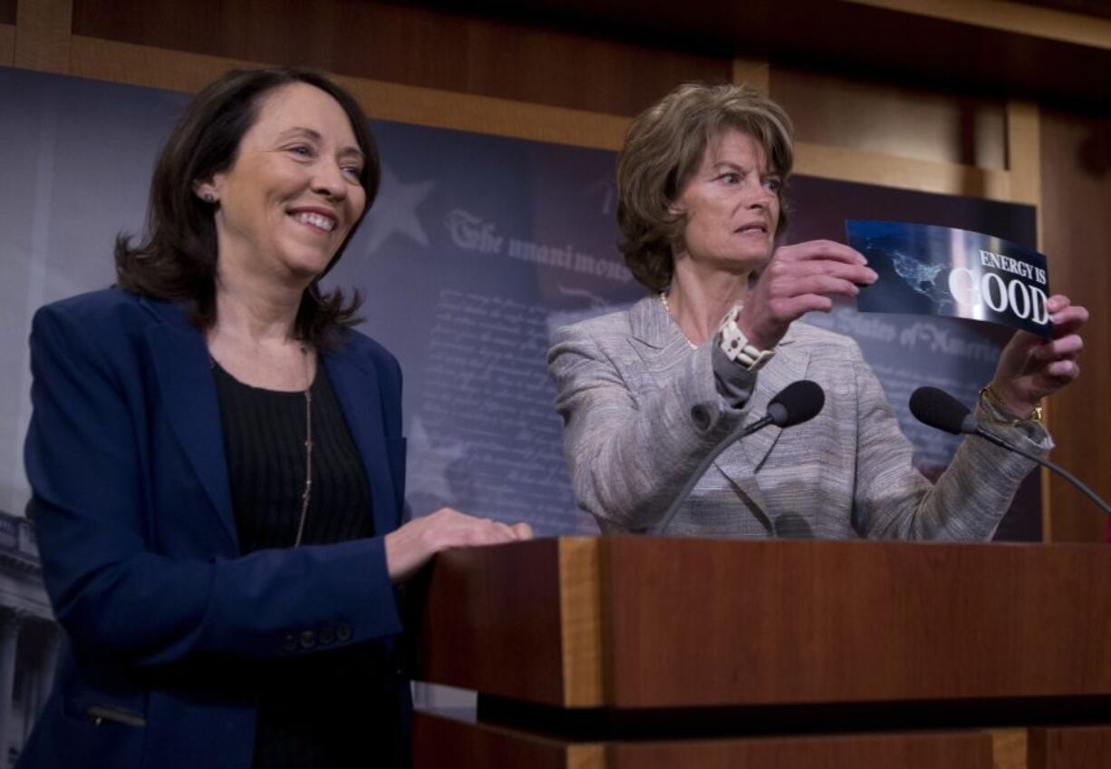 Senate Energy and Natural Resources Committee Chair Sen. Lisa Murkowski, R-Alaska, right, accompanied by the committee&#039;s ranking member, Sen. Maria Cantwell, D-Wash., holds a bumper sticker that reads &quot;Energy is Good&quot; during a news conference Wednesday on Capitol Hill.