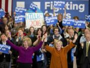 Democratic presidential candidate Hillary Clinton, right, is joined by Sen. Tammy Baldwin, D-WI, left, at a campaign event, Saturday, April 2, 2016, in Eau Claire, Wis.