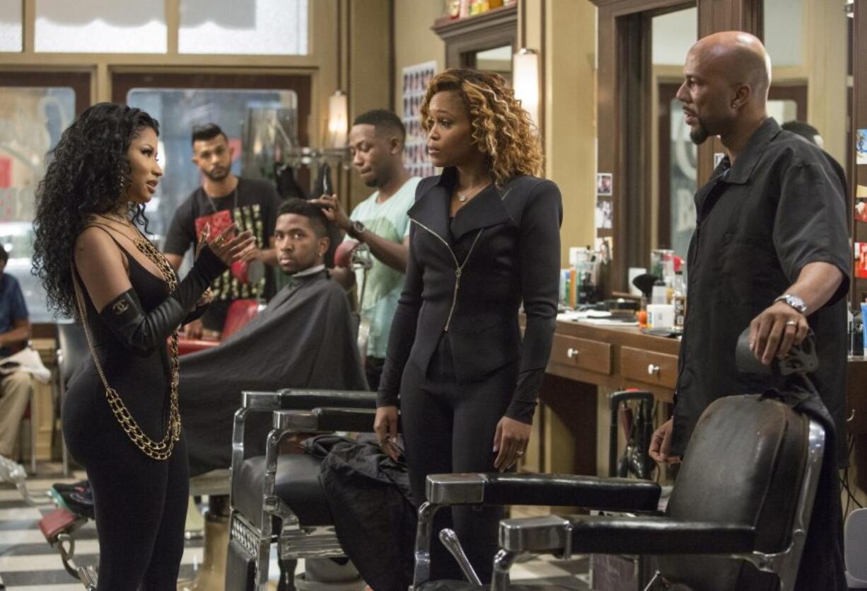 Nicki Minaj, foreground from left, Eve and Common discuss the issues of the day in &quot;Barbershop: The Next Cut.&quot; (Chuck Zlotnick/Warner Bros.)