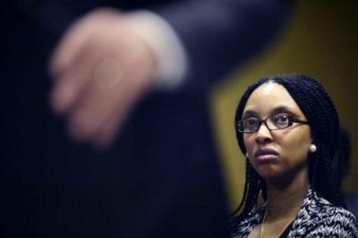 Shanika Mixon, of Flint, listens as attorneys speak during a press conference announcing a racketeering lawsuit targeting Gov. Rick Snyder and other state and local officials over lead contamination of the city?s drinking water, in Flint, Mich., on Wednesday.