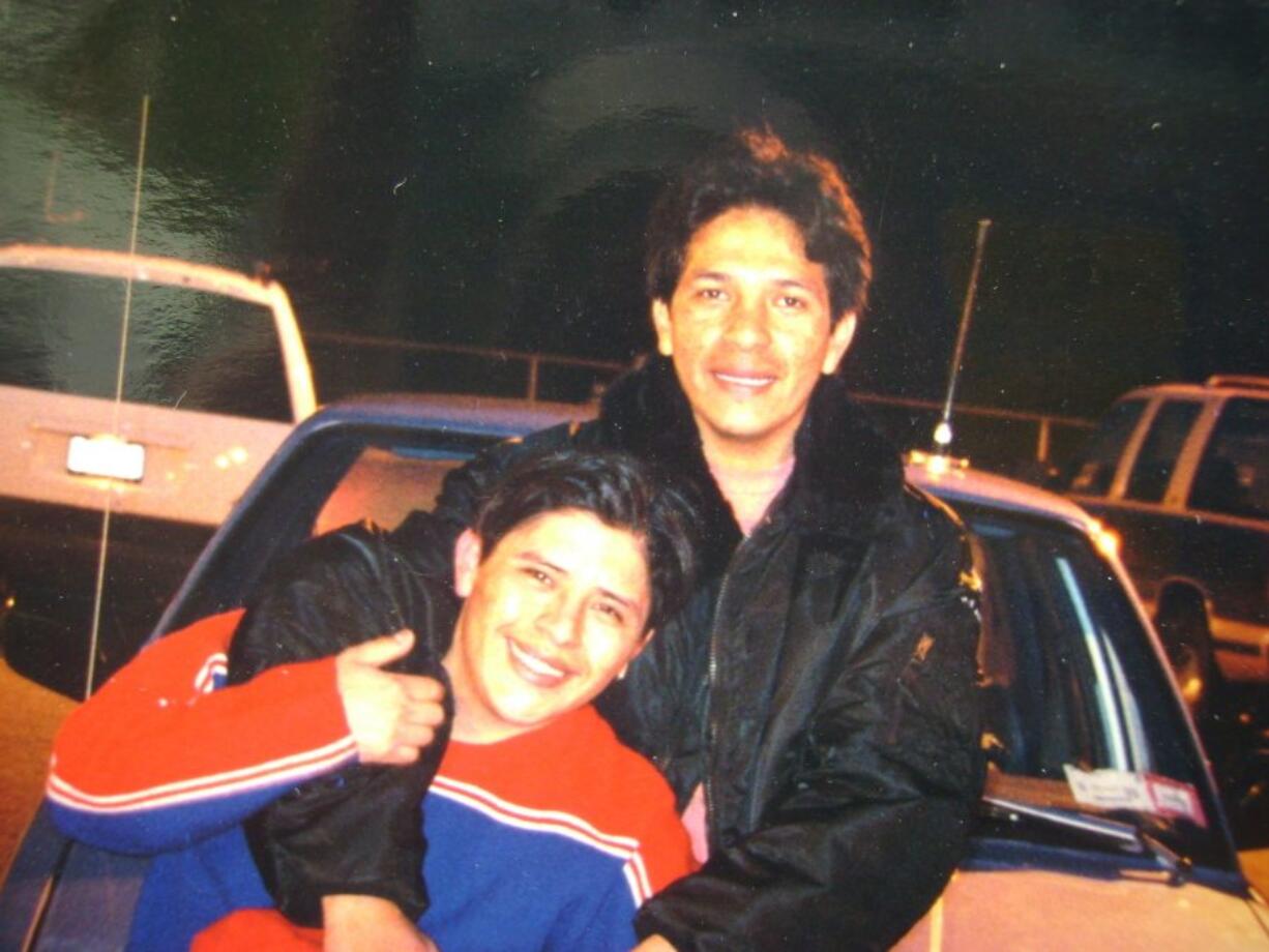 Marcello Lucero, top, playfully hugs his brother Joselo in Patchouge, N.Y., in 2000.