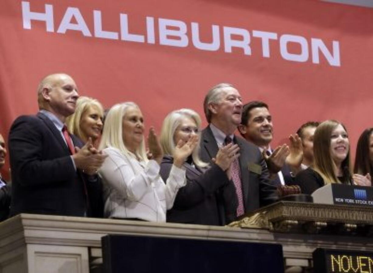 Halliburton Chairman, President and CEO David Lesar, third from right, rings the New York Stock Exchange opening bell.