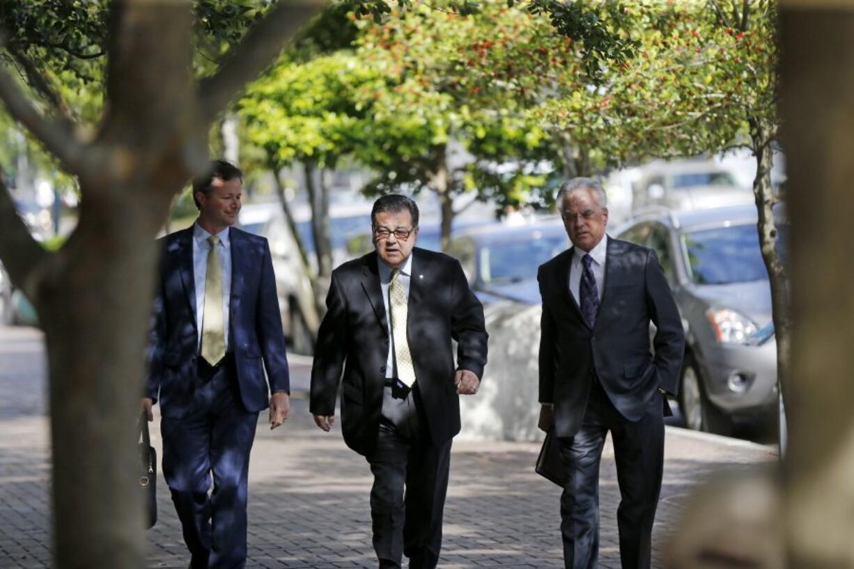 Former New Orleans Police Former Sgt. Arthur Kaufman, center, arrives at Federal Court in New Orleans on Wednesday. Five former New Orleans police officers are expected to enter pleas to reduced charges in the deadly shootings on a bridge in the days that followed Hurricane Katrina in 2005. Kaufman, who was not involved in the shooting, faces a new trial in the cover-up alone.