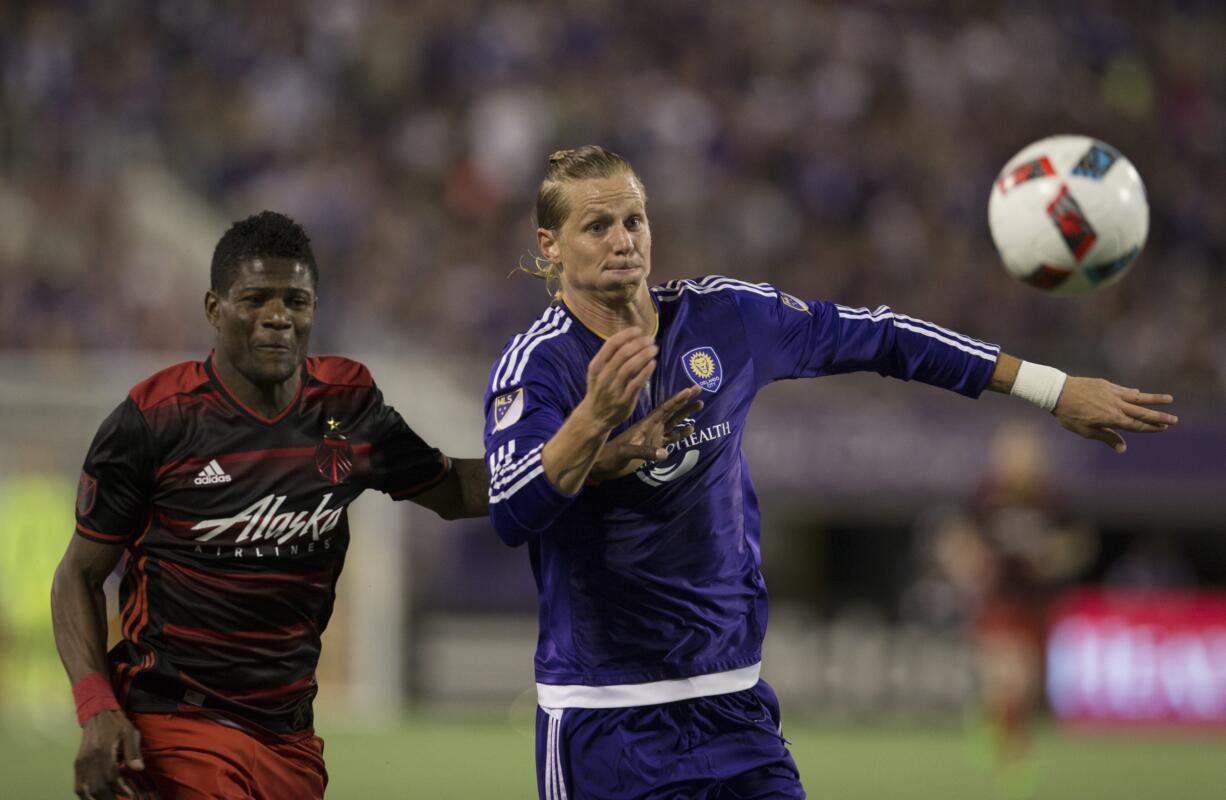 Orlando City FC midfielder Brek Shea, right, fights for the ball with Portland Timbers forward Dairon Asprilla in the first half of an MLS soccer game, Sunday, April 3, 2016, in Orlando, Fla.