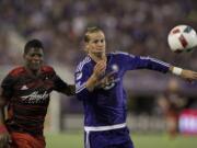 Orlando City FC midfielder Brek Shea, right, fights for the ball with Portland Timbers forward Dairon Asprilla in the first half of an MLS soccer game, Sunday, April 3, 2016, in Orlando, Fla.